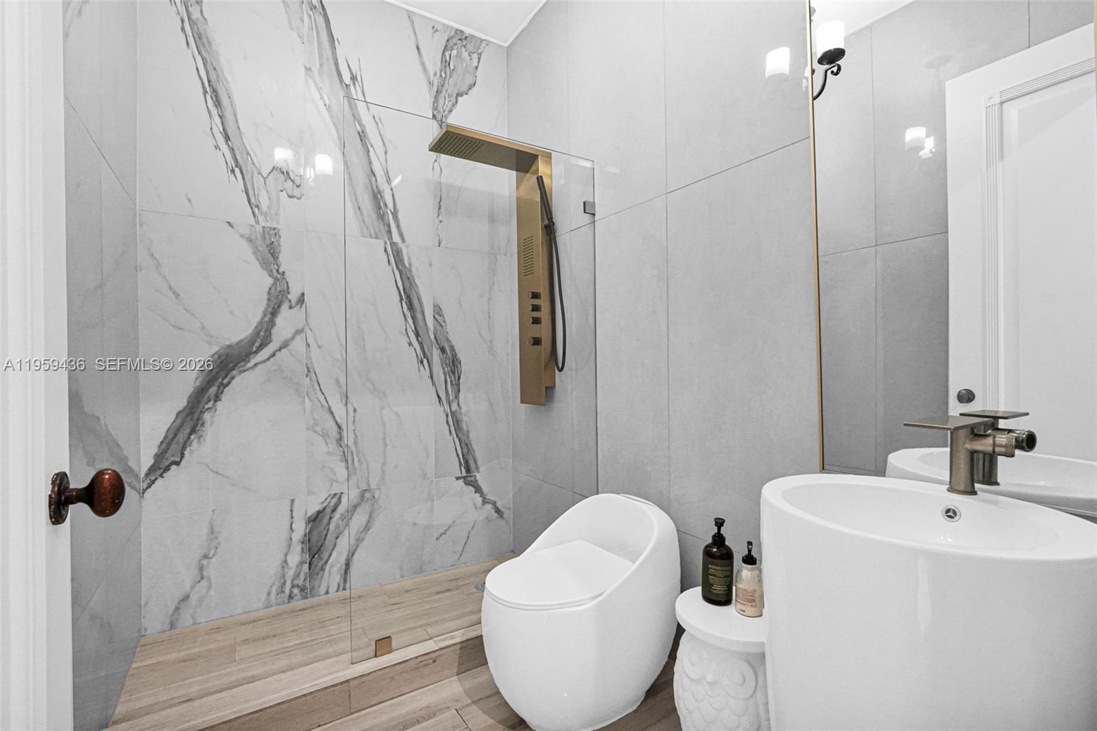 3675 Loquat Avenue Miami, FL 33133 - Photo 64 of 65 a bathroom with a toilet and a sink