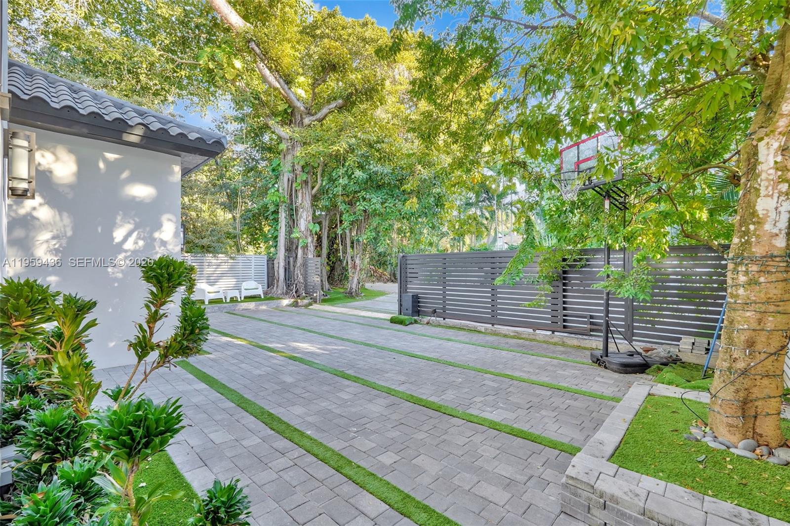 3675 Loquat Avenue Miami, FL 33133 - Photo 7 of 65 a front view of a house with a yard