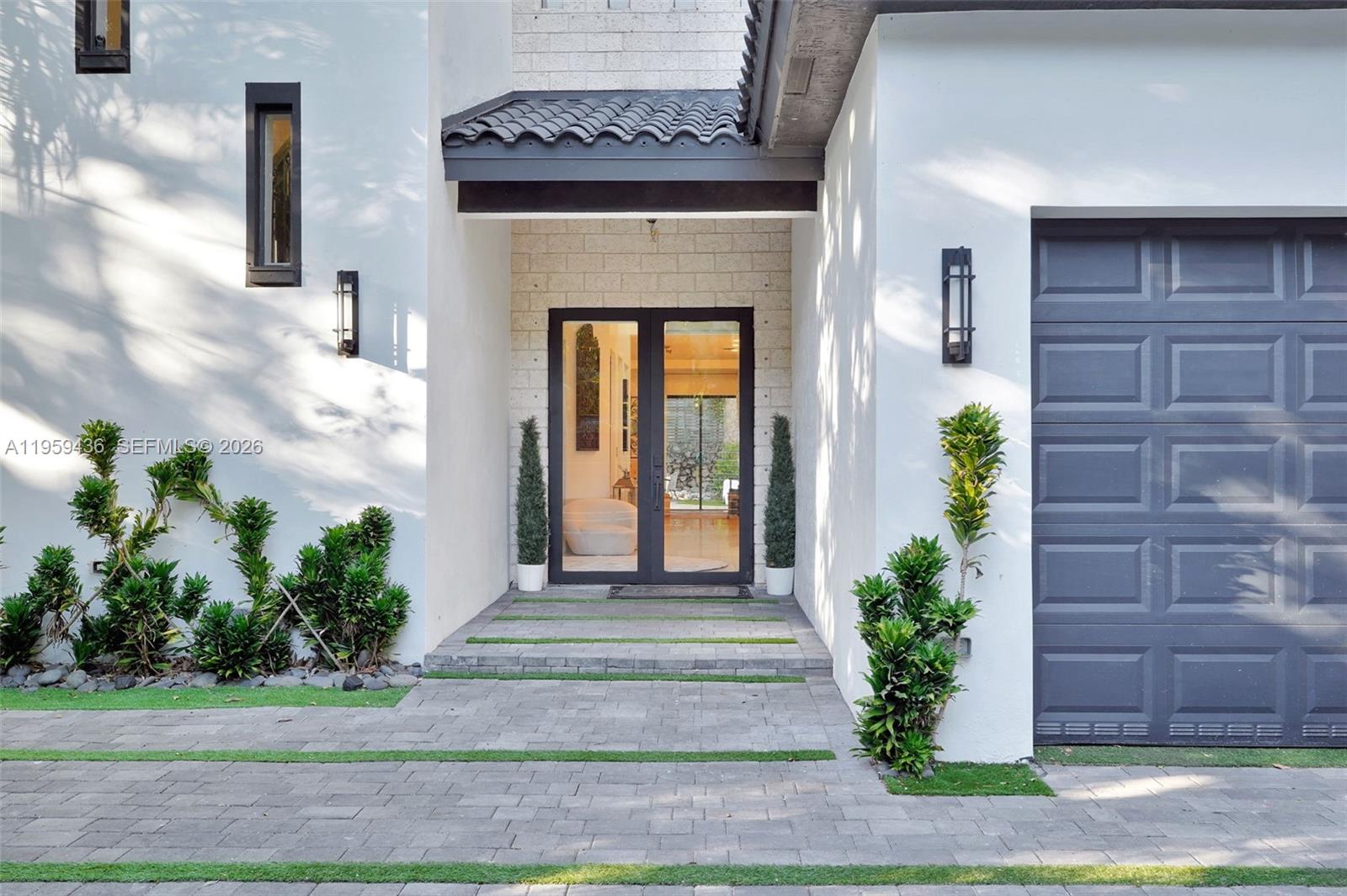 3675 Loquat Avenue Miami, FL 33133 - Photo 8 of 65 a front view of a house with plants