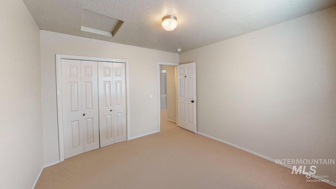 16609 Old Friendship Way Caldwell, ID 83607 - Photo 10 of 23 Carpeted flooring, window with horizontal blinds, flush mount ceiling light, and a white interior door
