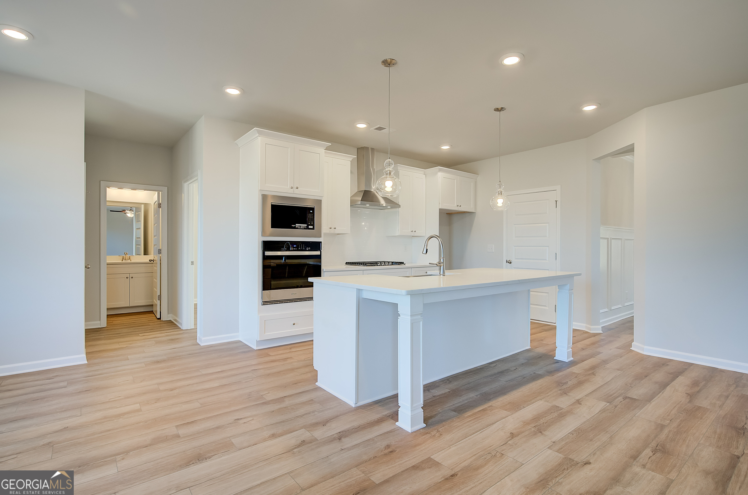 416 Hatcher Court Hampton, GA 30228 - Photo 13 of 30 a large kitchen with a center island wooden floor stainless steel appliances and cabinets