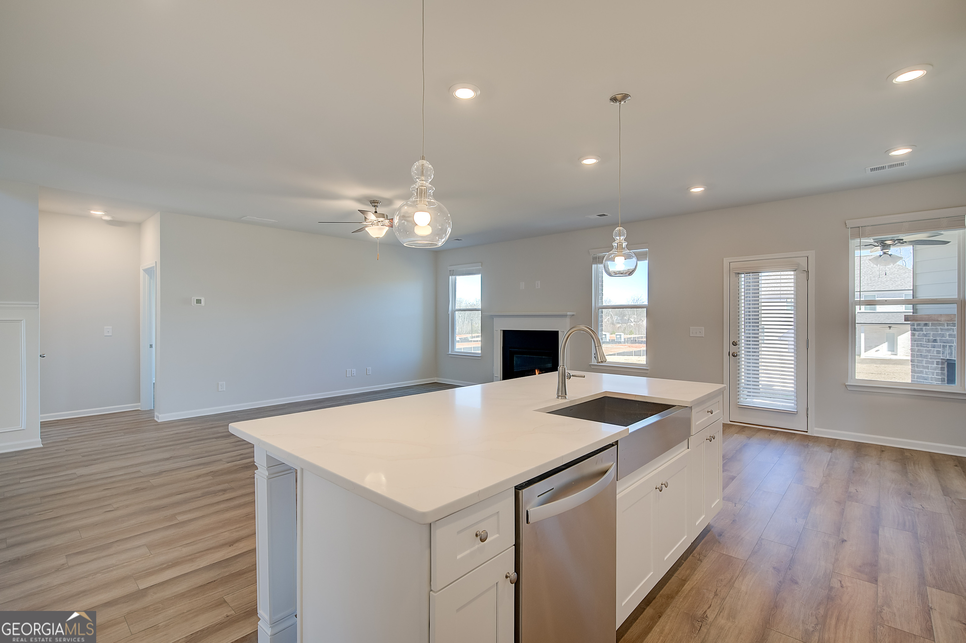 416 Hatcher Court Hampton, GA 30228 - Photo 15 of 30 a kitchen with a sink chandelier and wooden floor