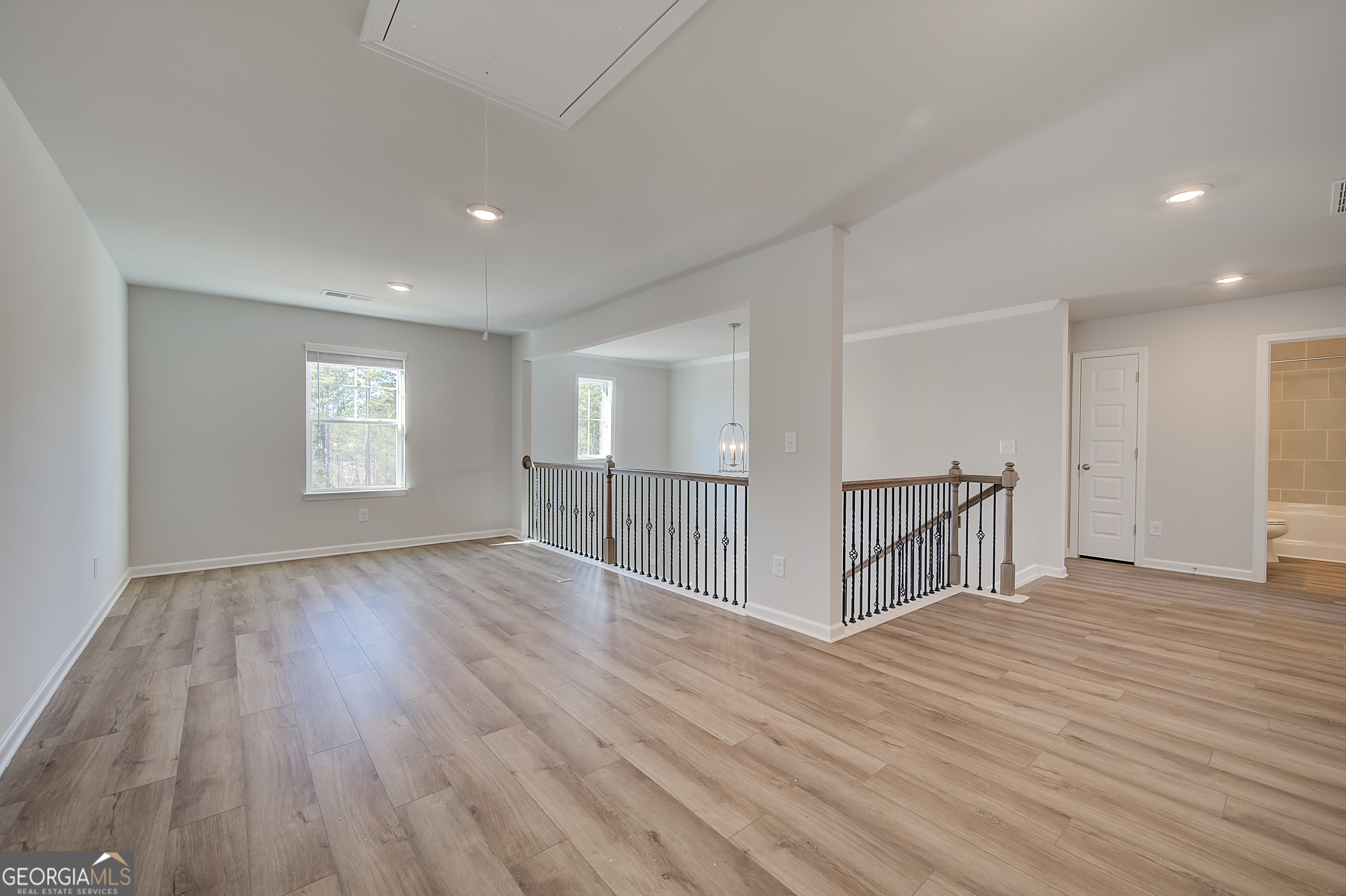 416 Hatcher Court Hampton, GA 30228 - Photo 21 of 30 a view of an empty room with wooden floor and a window