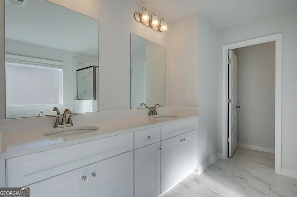 a white bath tub sitting next to a shower