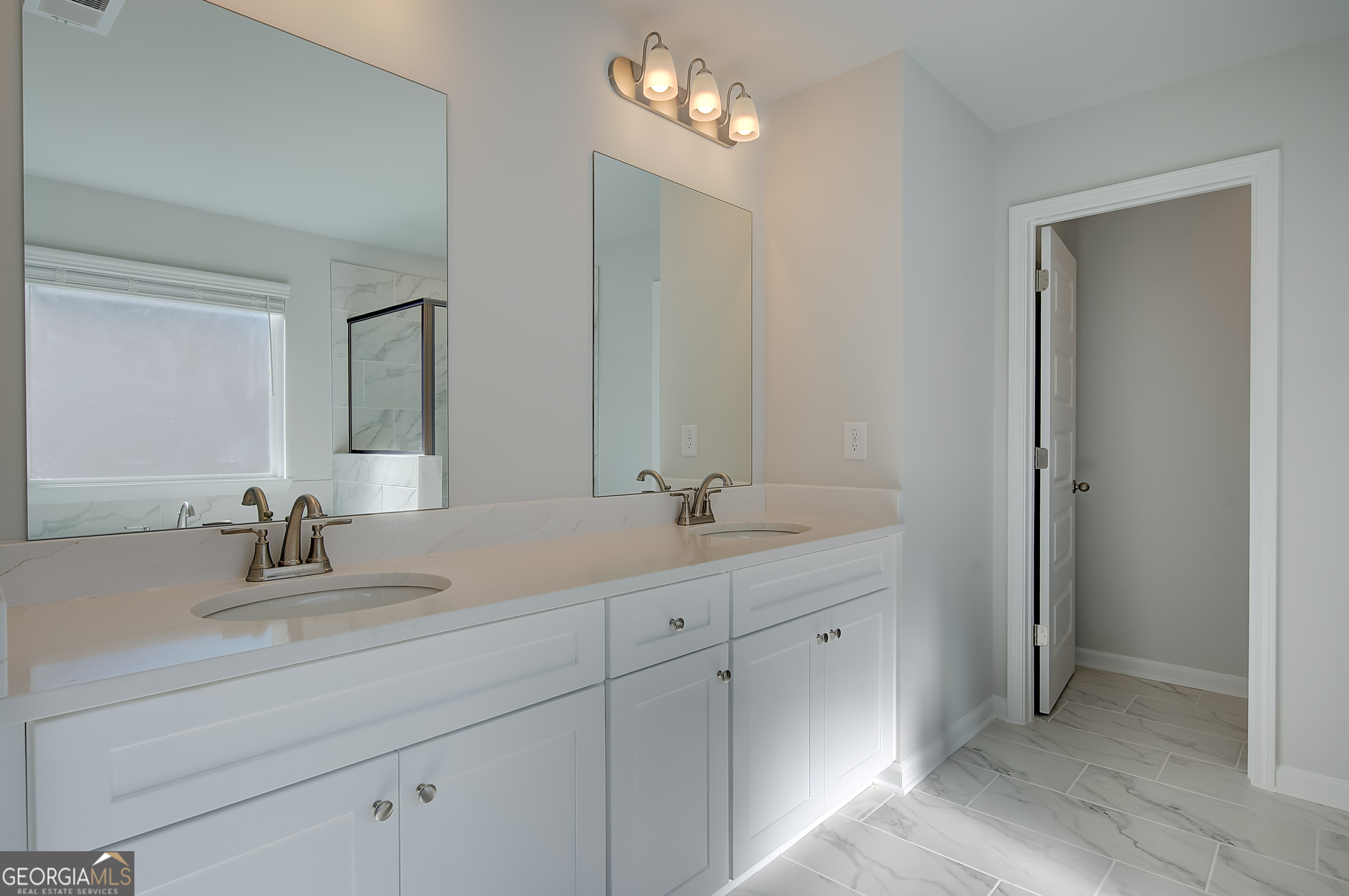 416 Hatcher Court Hampton, GA 30228 - Photo 26 of 30 a bathroom with double vanity sink and a mirror