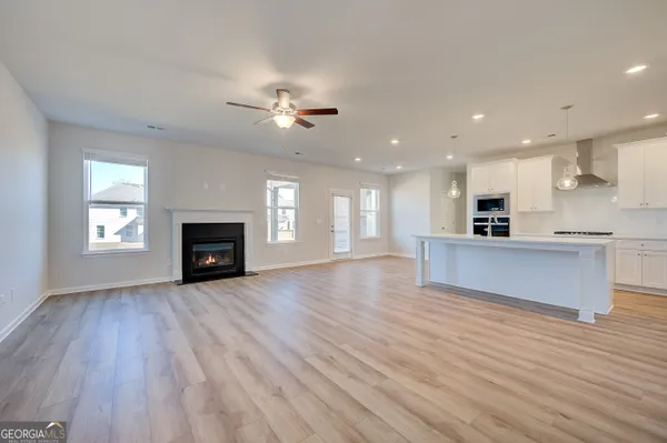 a view of kitchen with refrigerator and microwave