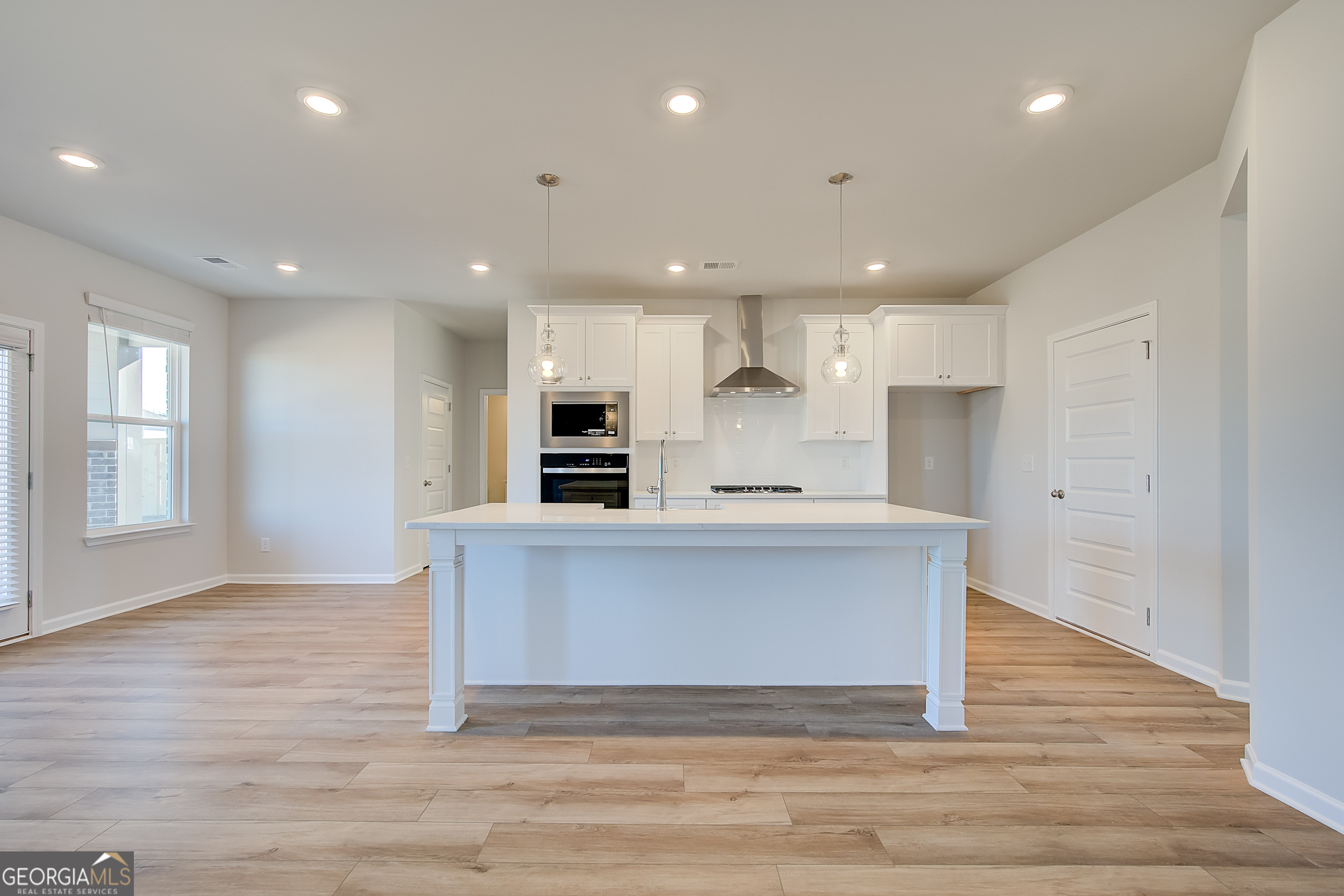 416 Hatcher Court Hampton, GA 30228 - Photo 10 of 30 a large kitchen with stainless steel appliances granite countertop a large counter top a sink and a refrigerator