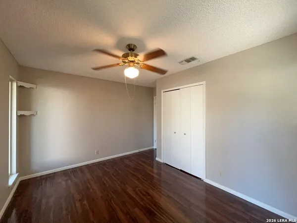 a bathroom with a granite countertop sink mirror and a shower