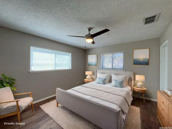 a bed room with a bed and a chair