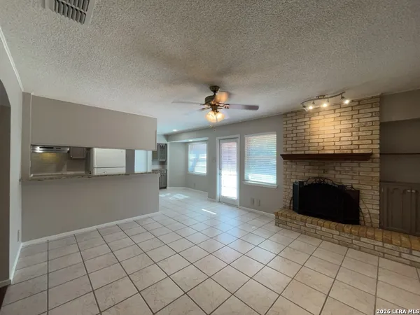 a view of an empty room and fire place