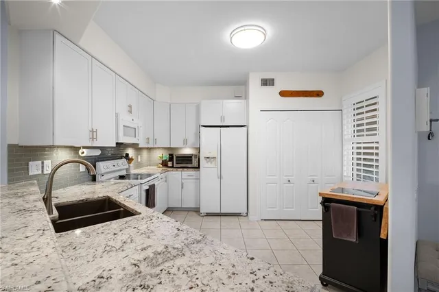 a kitchen with a sink a stove and refrigerator