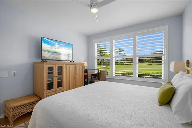 a bedroom with furniture and large windows