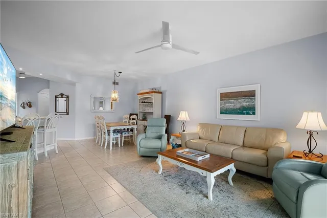 a living room with furniture a rug and a window
