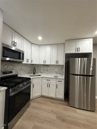 a kitchen with a refrigerator stove and microwave