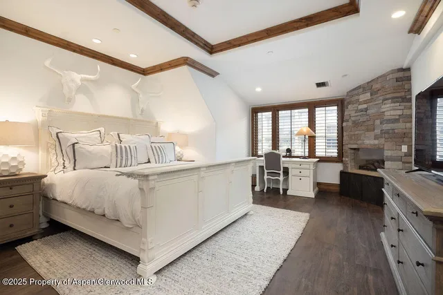 a spacious bedroom with a bed and a large window