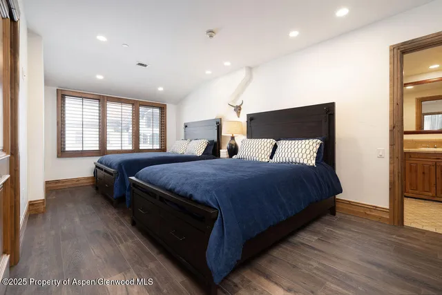 a spacious bedroom with a bed and a large window