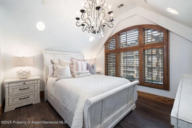 a bedroom with a large bed and a large window