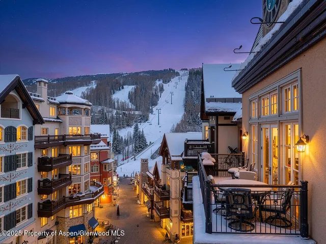 a view of a town with mountains in the background