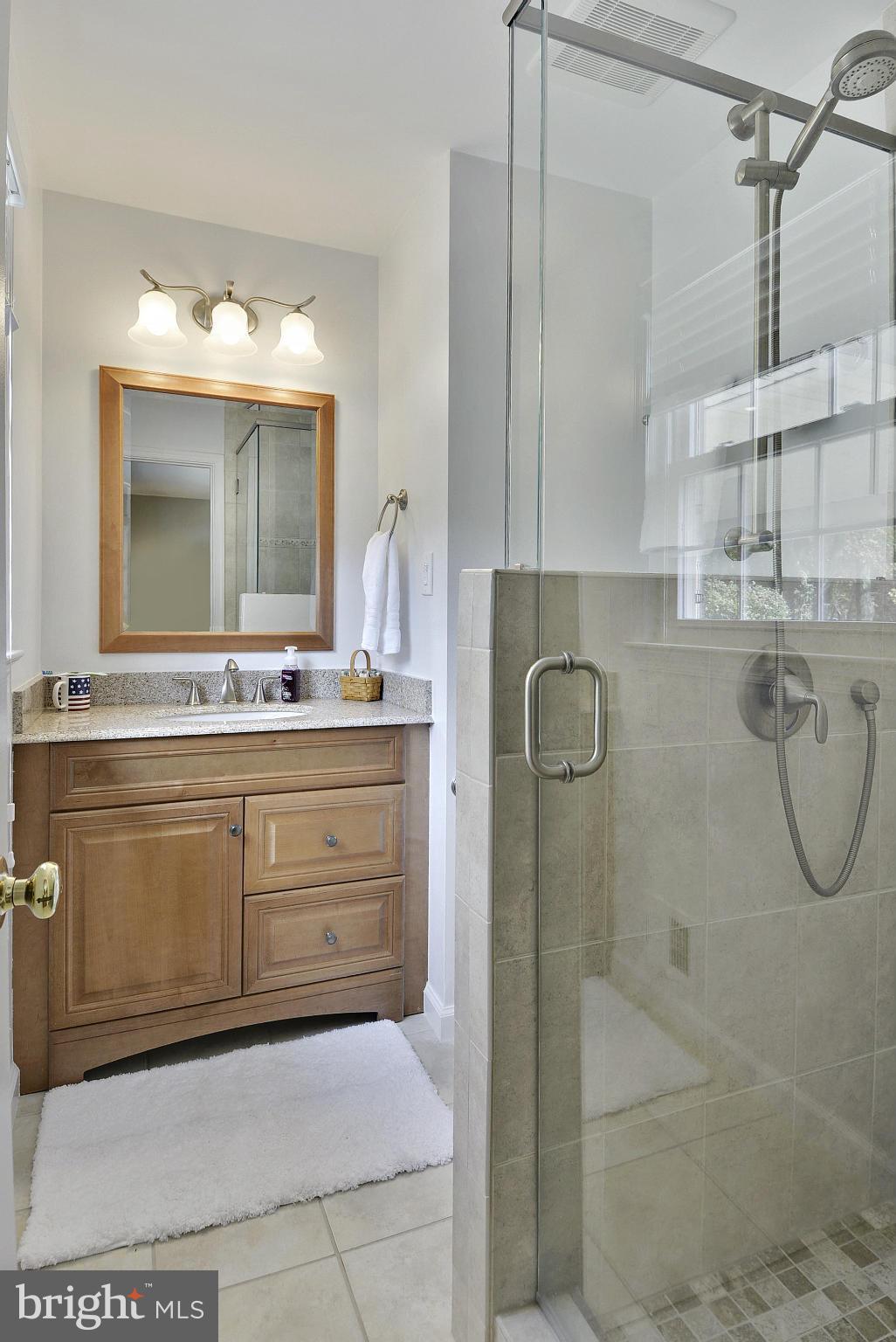 6731 Houndmaster Road Springfield, VA 22152 - Photo 12 of 30 a bathroom with a sink vanity and mirror