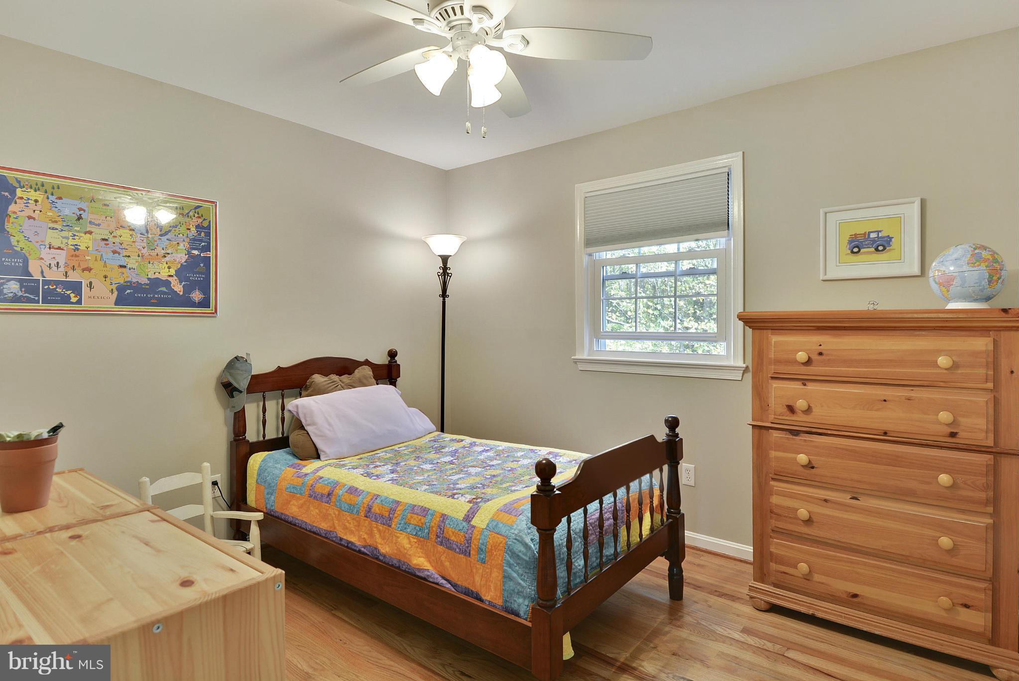 6731 Houndmaster Road Springfield, VA 22152 - Photo 13 of 30 a bedroom with a bed and cabinet