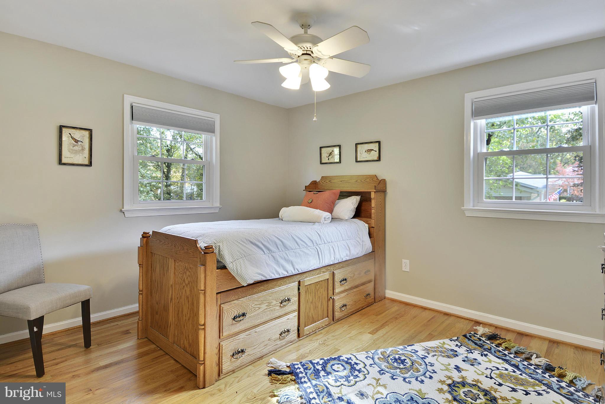 6731 Houndmaster Road Springfield, VA 22152 - Photo 14 of 30 a bedroom with a bed dresser and a window
