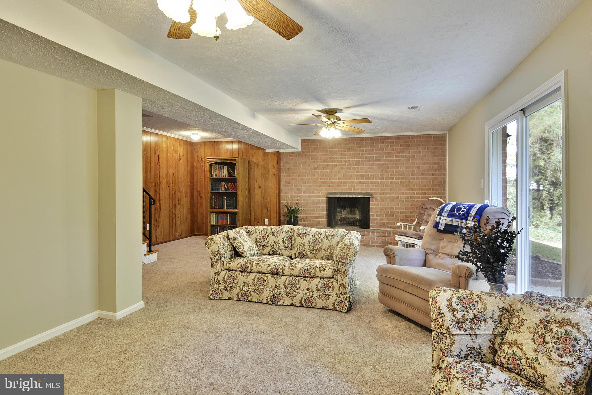 6731 Houndmaster Road Springfield, VA 22152 - Photo 16 of 30 a living room with furniture and a fireplace