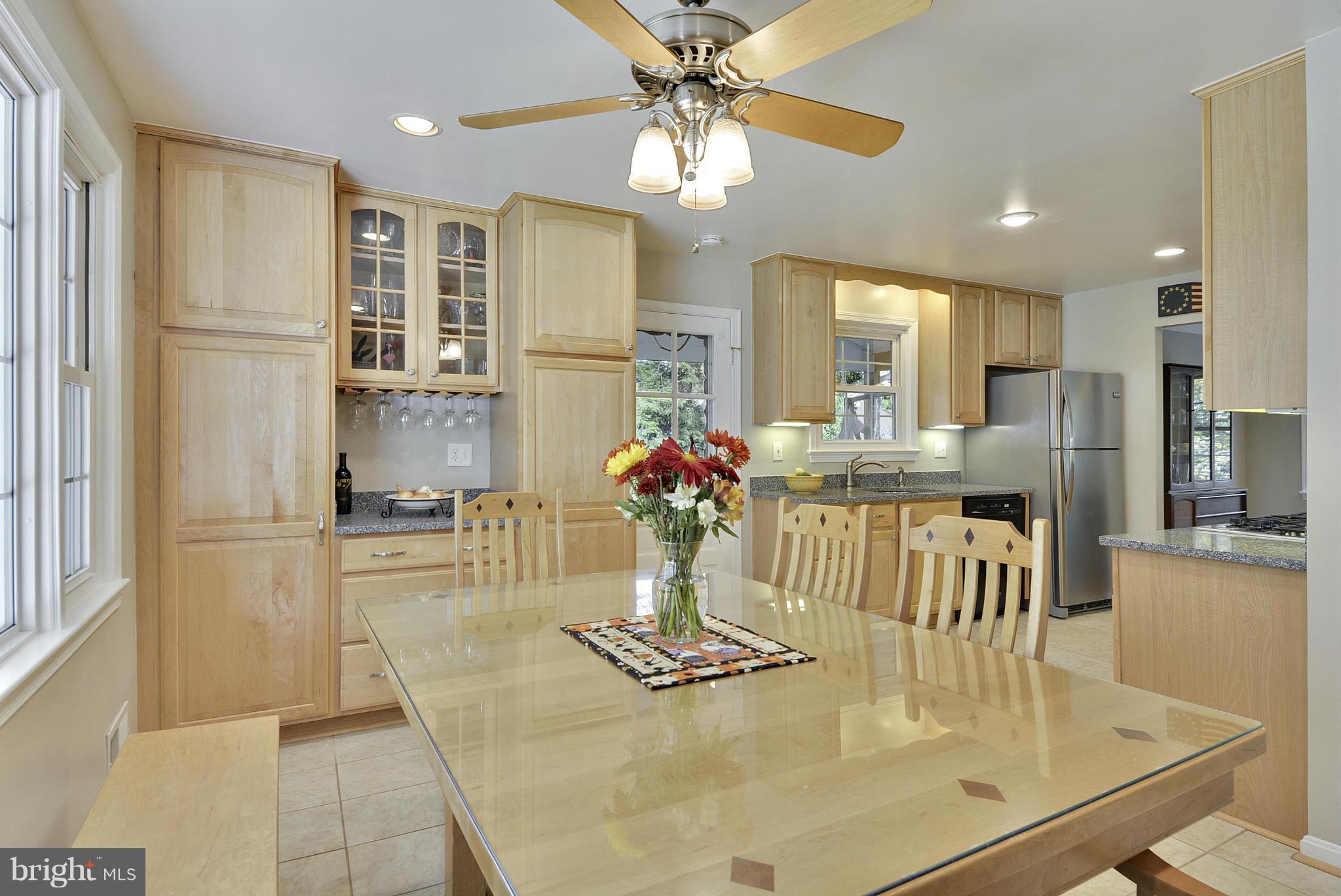 6731 Houndmaster Road Springfield, VA 22152 - Photo 3 of 30 a dining room with stainless steel appliances furniture a chandelier and kitchen view