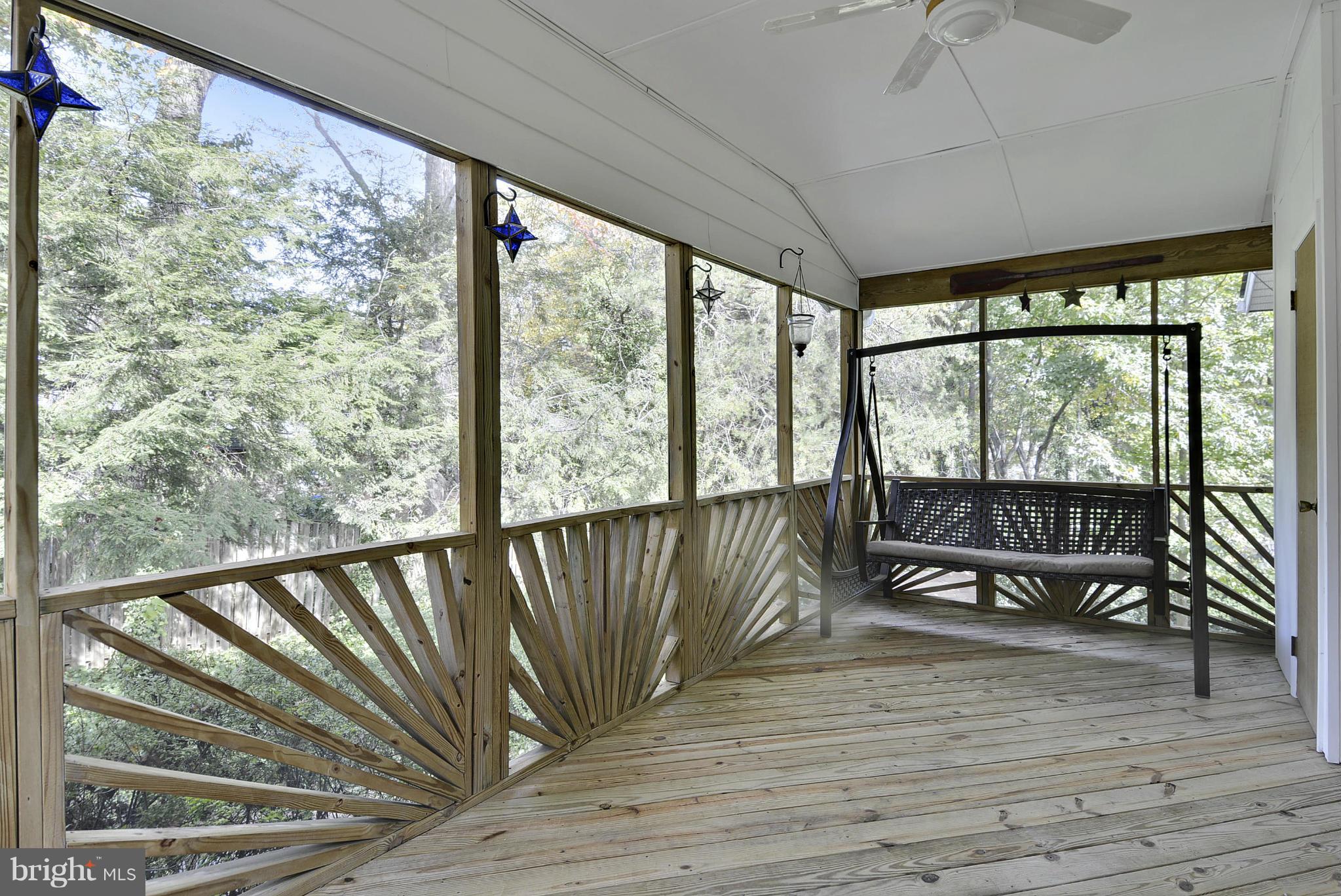 6731 Houndmaster Road Springfield, VA 22152 - Photo 23 of 30 a view of a balcony with chairs and wooden floor