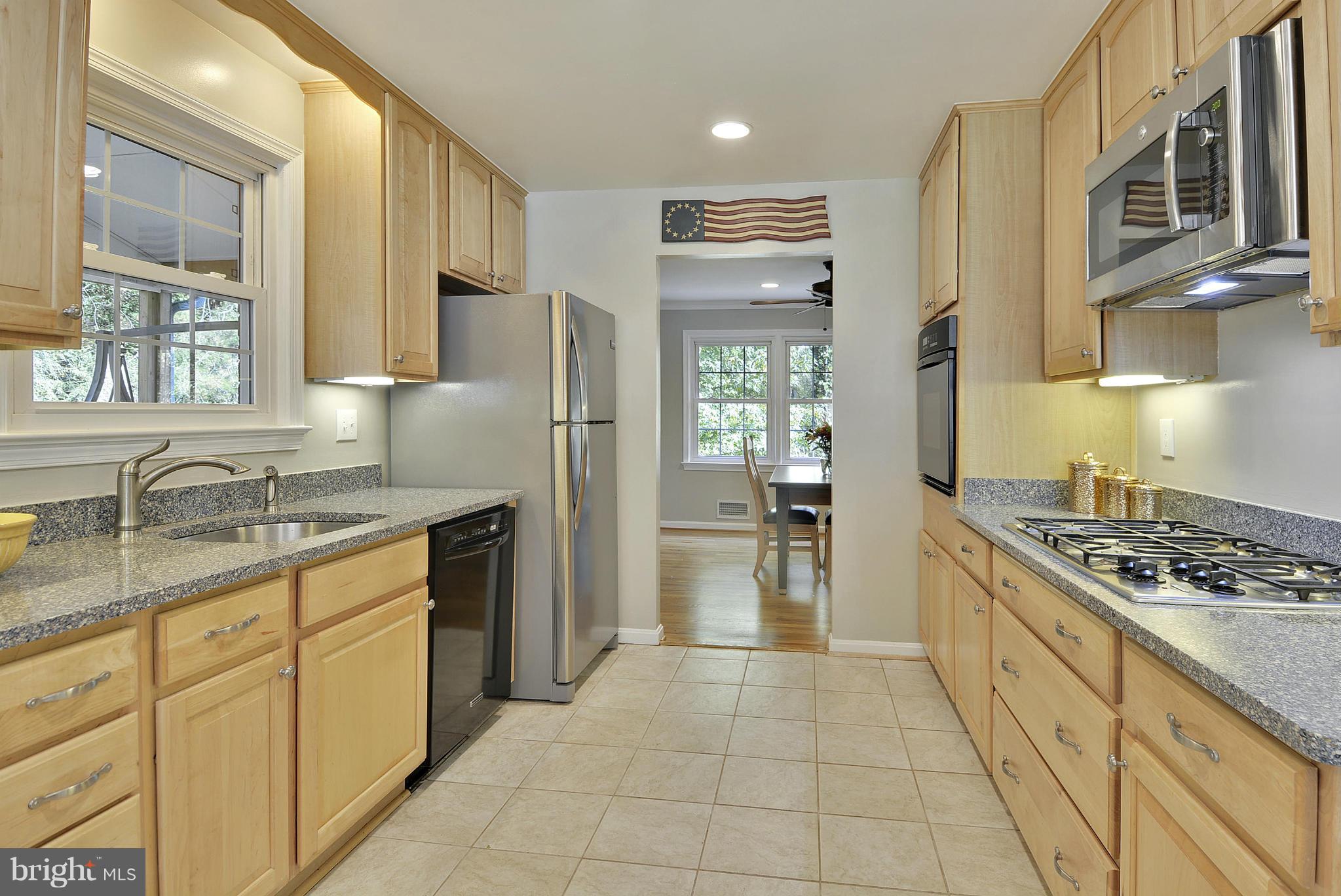 6731 Houndmaster Road Springfield, VA 22152 - Photo 5 of 30 a kitchen with stainless steel appliances granite countertop a sink stove and refrigerator