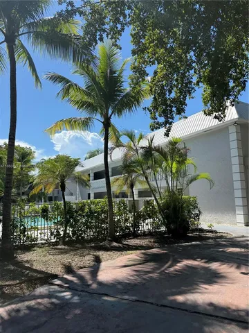 a view of a palm trees front of house