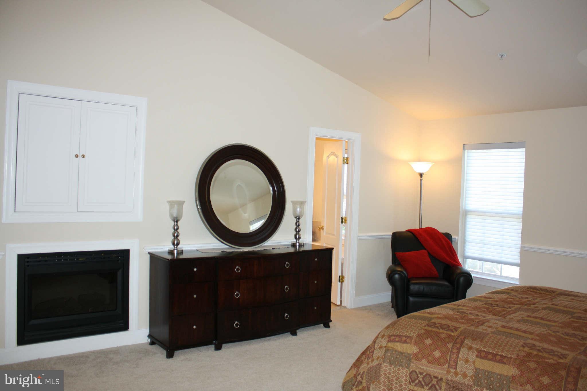 8075 Gatehouse Road, Unit 24 Falls Church, VA 22042 - Photo 17 of 24 a bedroom with a bed and a fireplace
