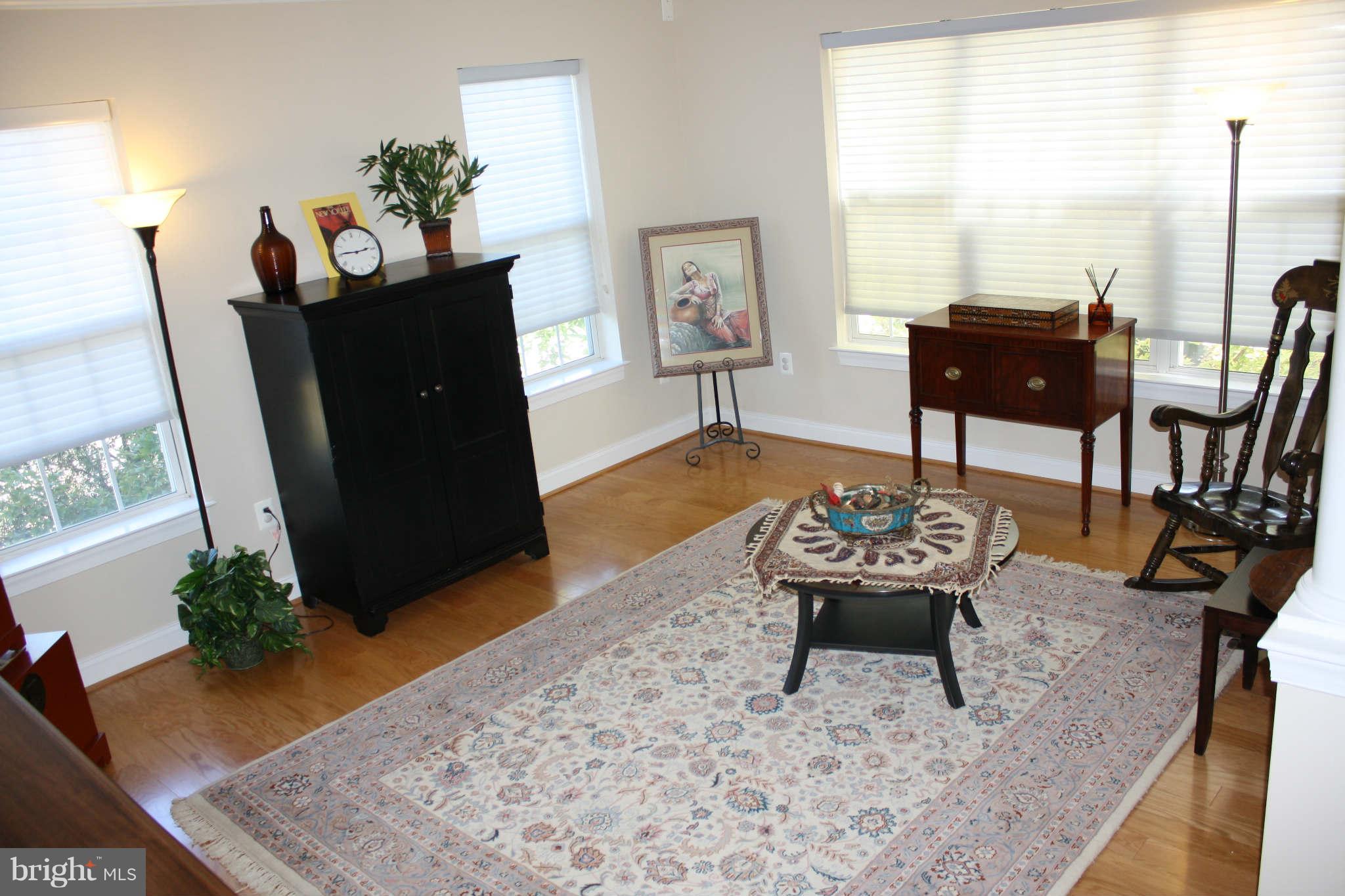 8075 Gatehouse Road, Unit 24 Falls Church, VA 22042 - Photo 3 of 24 a living room with furniture and wooden floor