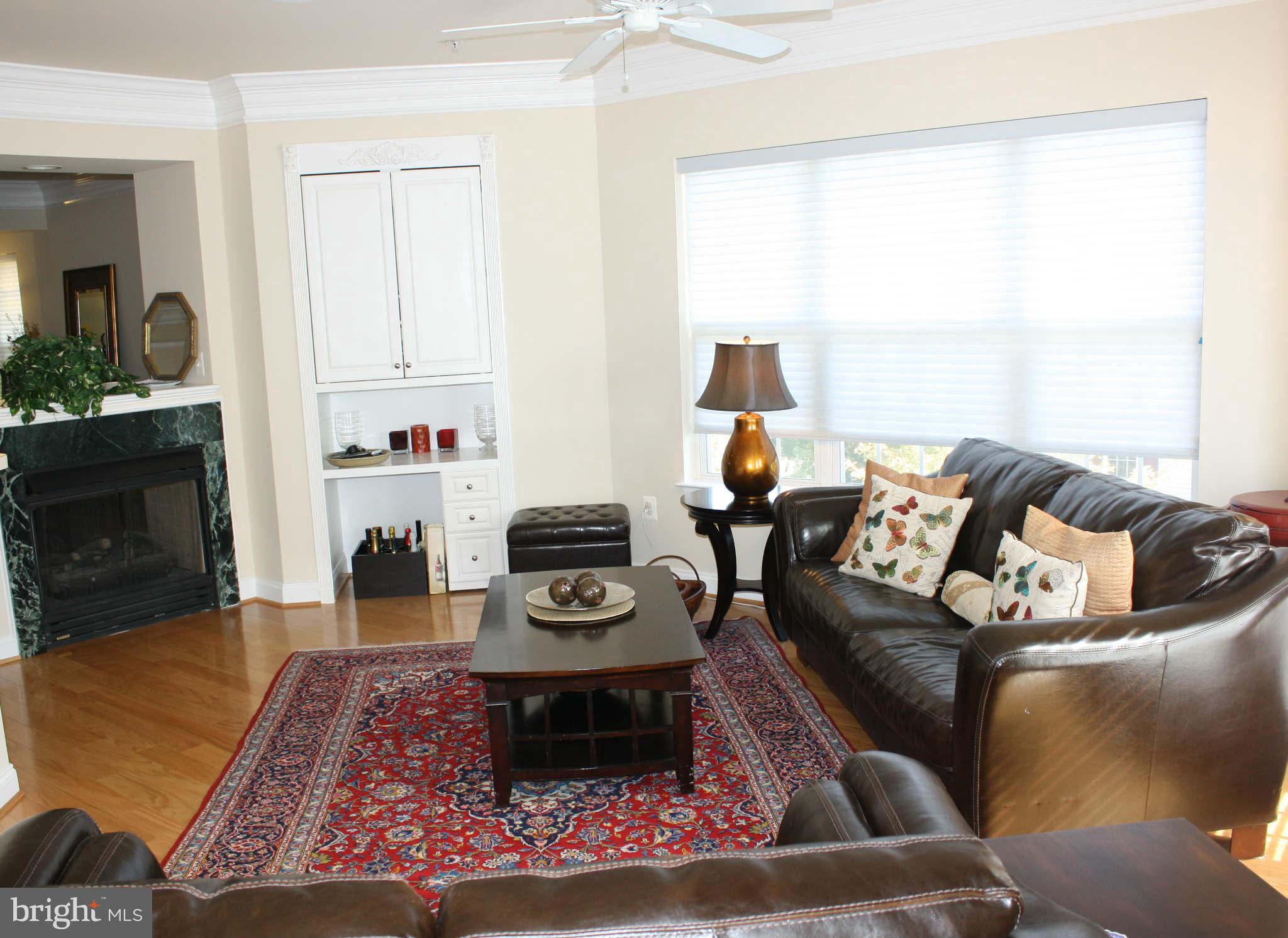 8075 Gatehouse Road, Unit 24 Falls Church, VA 22042 - Photo 7 of 24 a living room with furniture and a fireplace