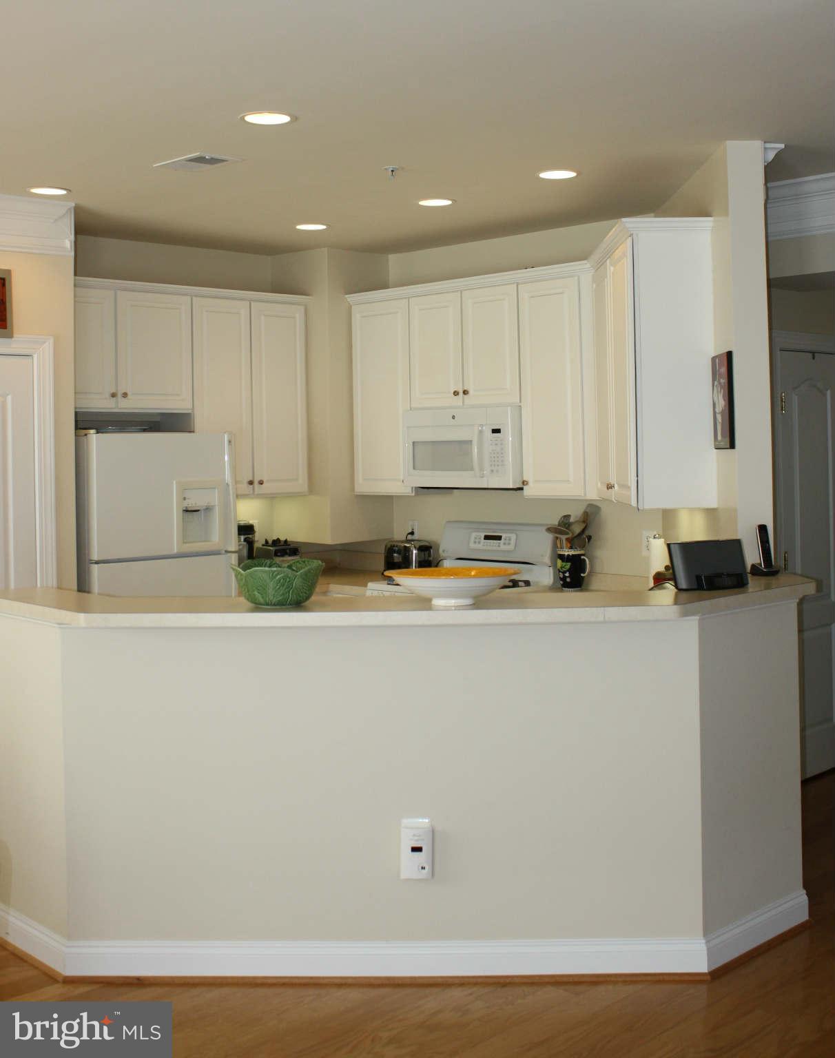 8075 Gatehouse Road, Unit 24 Falls Church, VA 22042 - Photo 10 of 24 a room with wooden floor and cabinets