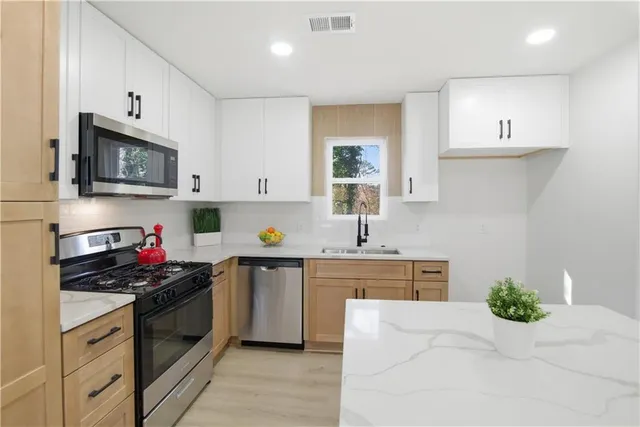 a kitchen with a sink stove top oven and microwave