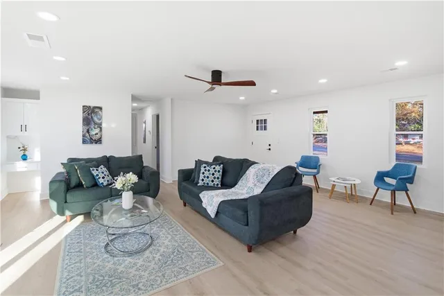 a living room with furniture and a wooden floor