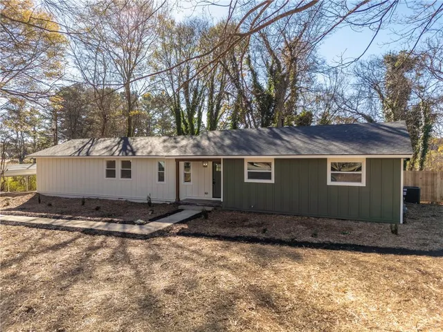 a front view of a house with trees