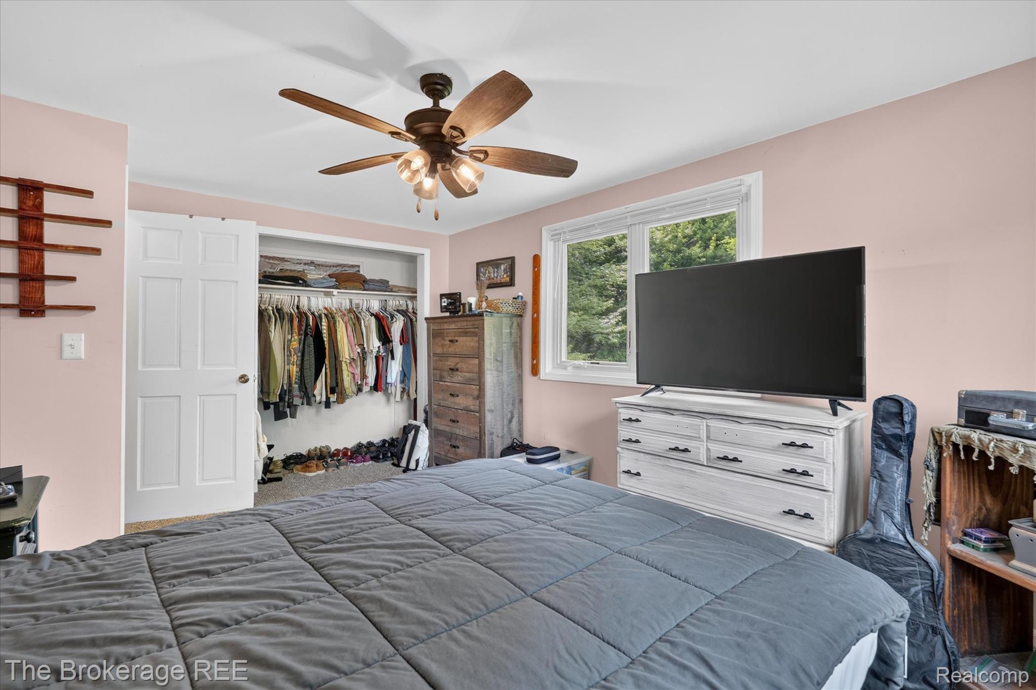 13269 North Genesee Road Clio, MI 48420 - Photo 22 of 67 Bedroom featuring a ceiling fan with integrated lighting, a window providing natural light, and a closet with bifold doors