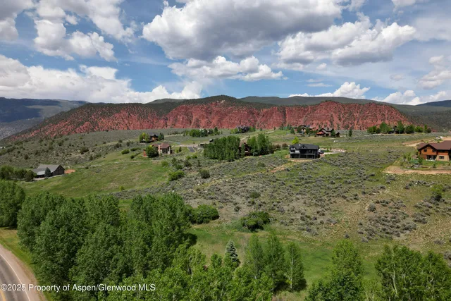a view of a lush green hillside and houses
