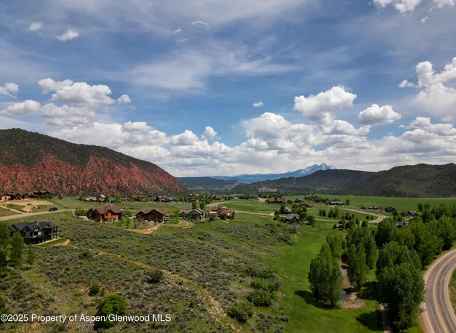 a view of a town with mountains in the background