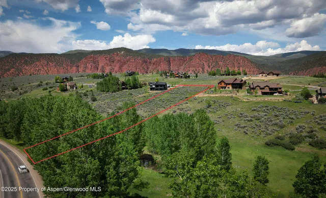 a view of a lush green hillside and houses