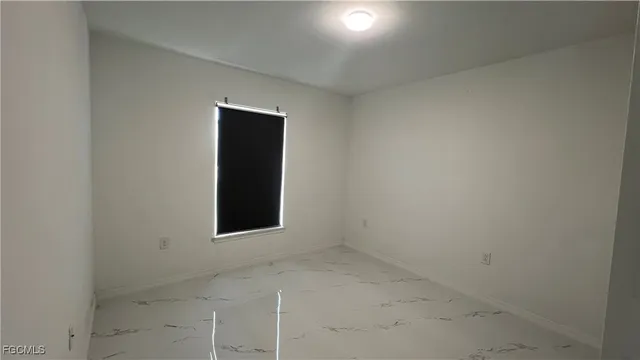 an empty room with wooden floor