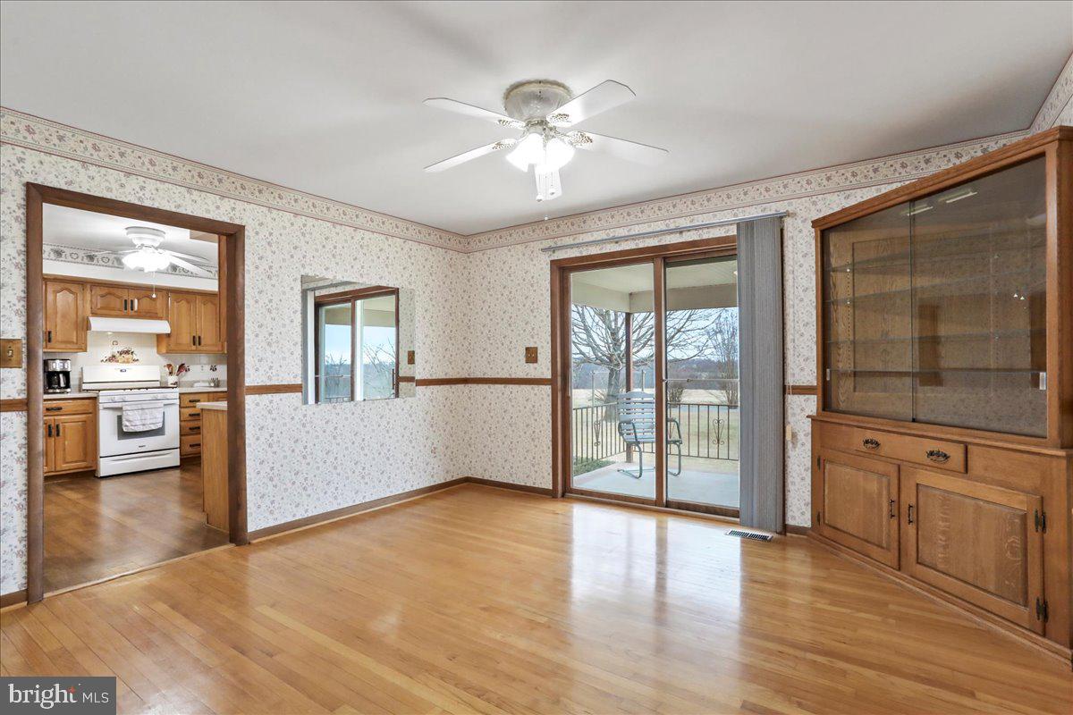 8920 Orndorff Road Emmitsburg, MD 21727 - Photo 65 of 91 a view of an empty room with wooden floor and a kitchen