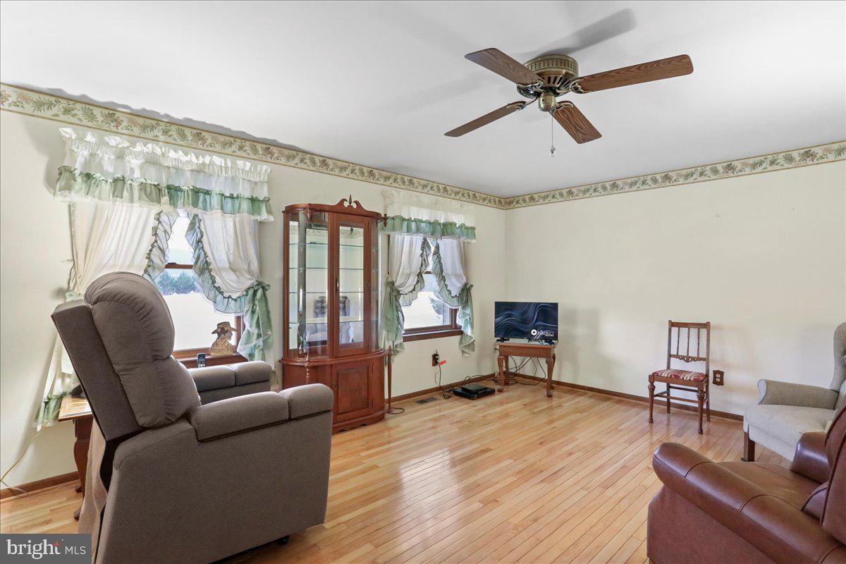 8920 Orndorff Road Emmitsburg, MD 21727 - Photo 69 of 91 a living room with furniture ceiling fan and a wooden floor