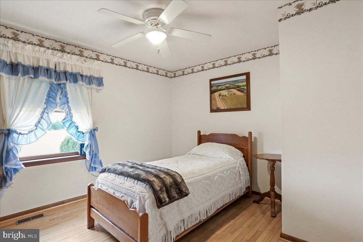 8920 Orndorff Road Emmitsburg, MD 21727 - Photo 71 of 91 a bedroom with a bed and a chandelier