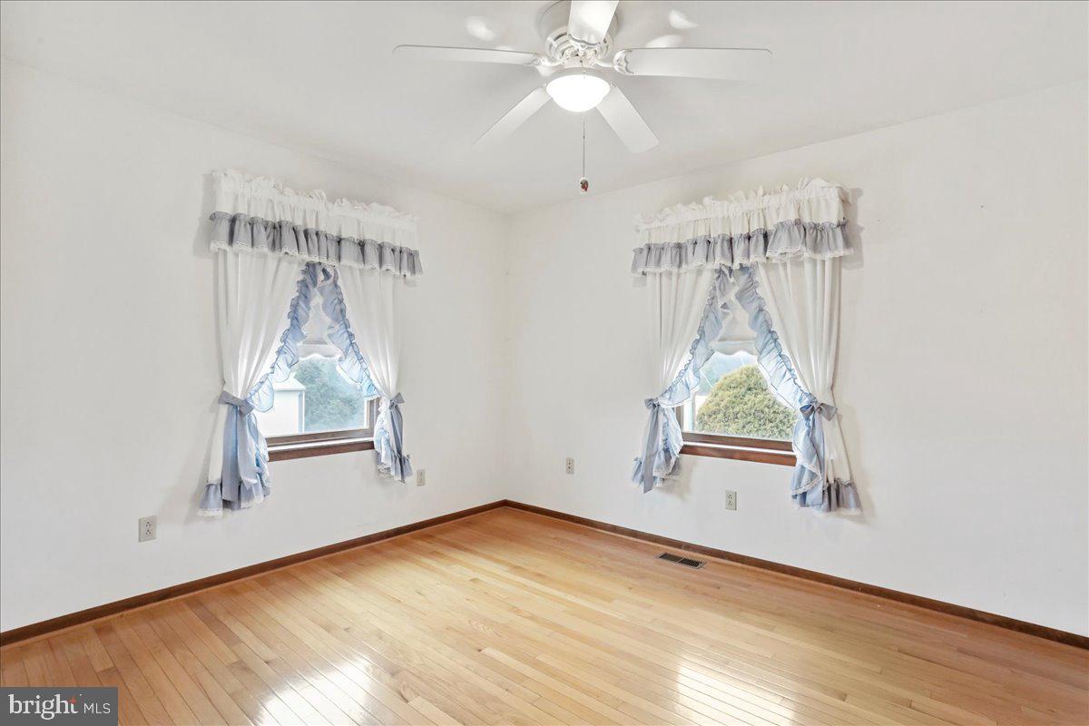 8920 Orndorff Road Emmitsburg, MD 21727 - Photo 75 of 91 an empty room with wooden floor fan and windows