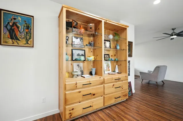 a living room with furniture gym equipment and a large window