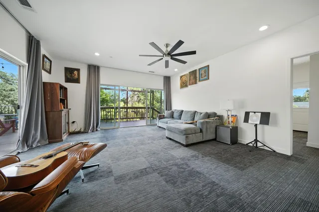 a living room with furniture a table and wooden floor