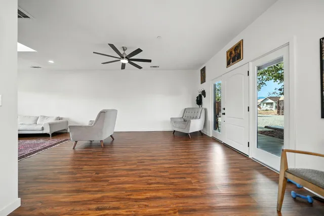 a view of a livingroom with furniture and a ceiling fan