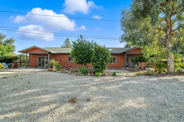 an aerial view of a house with yard